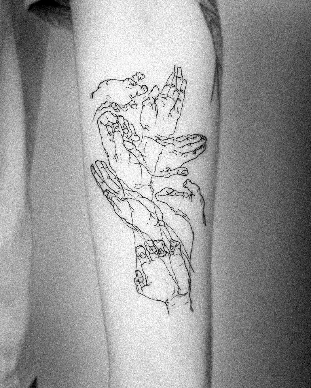 Fine line sketch of tangled hands wrapping the forearm